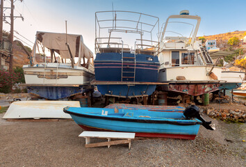 Repaired fishing boats on carts on the shore of the bay in the village of Symi.