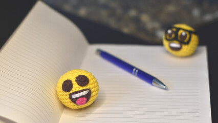 notebook, pen, nerd emoji and happy emoji amigurumis