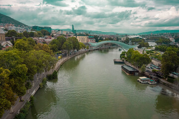 Fototapeta premium The Kura river, The Bridge of Peace, the cathedral, churches and the magnificent view of Tbilisi city from the cable car.