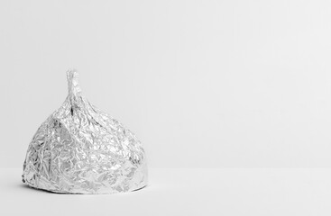 Aluminium foil hat on light gray background, symbol for conspiracy theory and mind control protection. Top view. Space for text