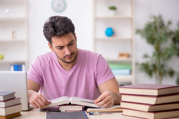 Young male student sitting in the classroom