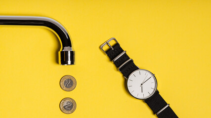 concept. metal tap spout on a yellow background, Polish zloty coins arranged in a row, and a watch with a white dial lying next to it. bright yellow image - obrazy, fototapety, plakaty