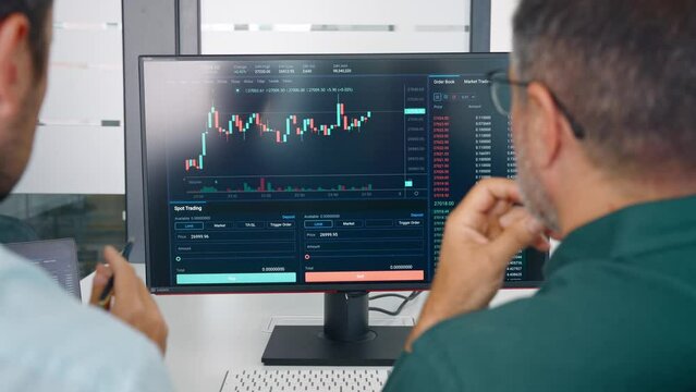Financial advisor consulting investor discussing financial trading data. Two stock traders analysing crypto market investment strategy doing digital online finance forecast at meeting. Close up screen