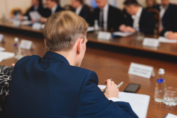 Fototapeta premium Group of men in business suits talking and discussing at conference, politicians and entrepreneurs debate, networking and negotiate, businessmen have dialog conversation on a forum, panel discussion