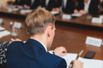 Group of men in business suits talking and discussing at conference, politicians and entrepreneurs...