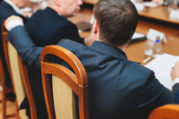 Group of men in business suits talking and discussing at conference, politicians and entrepreneurs...