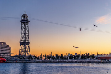 Barcelona, Spain - November 26, 2021: Steel Torre Jaume I tower and Port Vell Aerial Tramway cable...