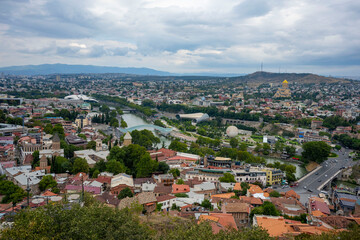 Fototapeta premium The Kura river, The Bridge of Peace, the cathedral, churches and the magnificent view of Tbilisi city from the cable car.