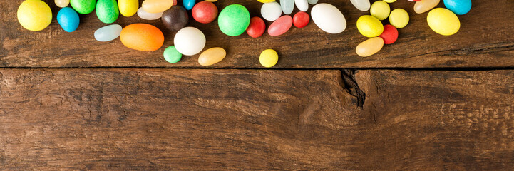 Overhead view of different sweets on wooden background. Unhealthy food concept