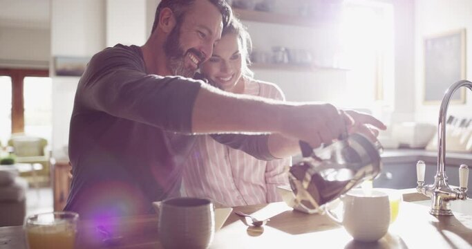 Couple, man or woman and coffee in kitchen for morning breakfast, caffeine or wellness in home with sunlight. People, espresso or talking on weekend for peace, relax and bonding with love or care