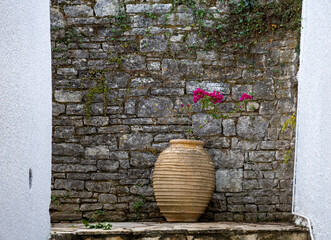 flowers in a vase on the wall