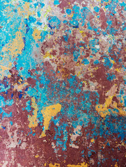 Abstract colorful grunge background. Weathered cement wall with peeling paint. Aged scratched cement wall. Colorful grungy concrete wallpaper. Old wall texture for web banner and copy space.