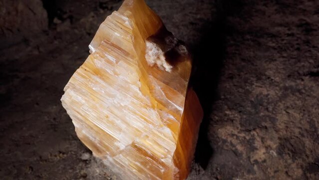 The crystalline yellow stone is still attached to the host rock in its natural environment. Mine of precious stones