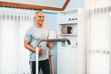 Active senior man running on tread running machine at home together as fitness healthy lifestyle and body care after retirement for pensioner. Clout
