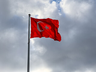  Turkish flag waving in blue cloudly sky. 19 mayis, 23 nisan, 15 temmuz, 30 agustos, 29 ekim, 10 kasim. Turkish nation. 19 may, 23 april, 15 july, 30 august, 29 october.