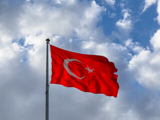  Turkish flag waving in blue cloudly sky. 19 mayis, 23 nisan, 15 temmuz, 30 agustos, 29 ekim, 10 kasim. Turkish nation. 19 may, 23 april, 15 july, 30 august, 29 october.