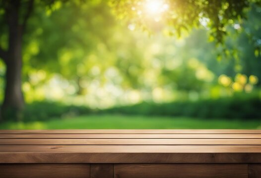 Wooden table top on blur background of green garden with bokeh sunlight High quality photo