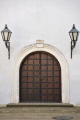 Very old solid door in brick stone wall of castle or fortress of 18th century. Full frame wall with door close up