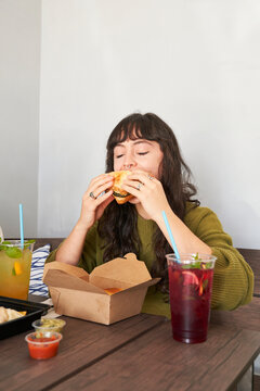 Friends eating takeout food at table