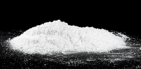 Large pile of white snow isolated on a black background. White fluffy snow.