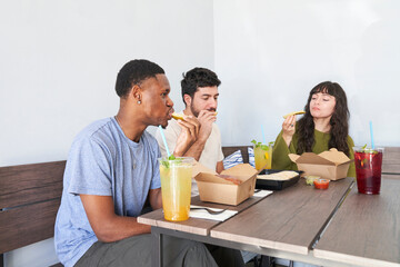 Friends eating takeout food at table