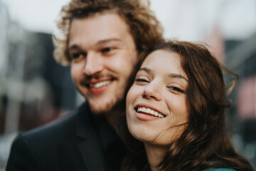 A confident, attractive couple outdoors, looking at the camera(girl) and looking away(boy) with smile.