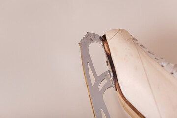 Close-up of vintage ice skates on a neutral background, representing winter sports, nostalgia, and...