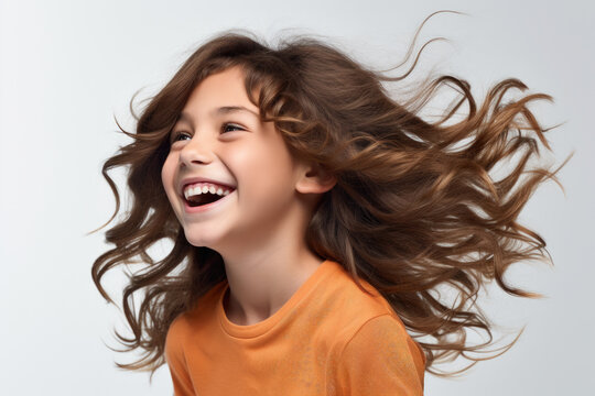 Young girl with long brown hair smiles warmly. This picture can be used to portray happiness, joy, and positivity. It is suitable for various projects and designs