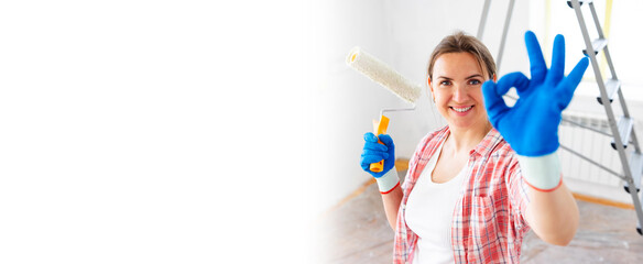 Banner young smiling woman with roller brush showing ok gesture, copy space