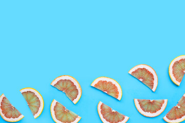 Grapefruit Slices on blue background. Copy space