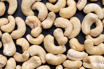 Cashew nuts on dark background.
