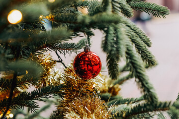 Christmas fir tree decorations with red and gold baubles. New Year celebration concept. Copy space.