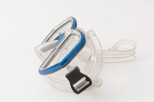 A pair of blue diving goggles, snorkeling mask isolated on white background, perspective view