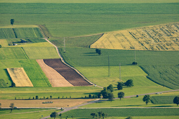Summer fields with roads, trees and power lines