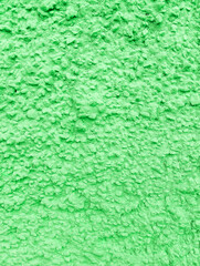 Abstract green rough wall textured background with copy space. Rough painted cement wall texture.