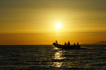 Water activities concept with silhouette of motor boat driving on the sea