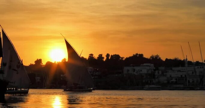 Traditional felucca sailboat on Nile at sunset, Aswan, Egypt