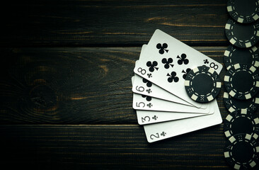A very gambling game of poker with a winning straight flush combination. Playing cards with chips...