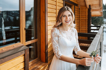 The bride in a white wedding dress is waiting for the groom. The first meeting of the bride and groom. Wedding in nature in winter.