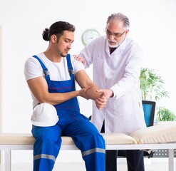 Young male contractor visiting old doctor