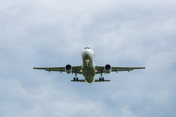 Passenger jet plane coming in for a landing. View from below. Jet commercial aviation. The plane flies towards the photographer