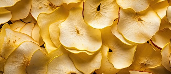 In the macro perspective, a heap of sliced and wrinkled dried apple slices can be seen, creating a pile of white and yellow fruit that serves as a popular ingredient in many dried food recipes.