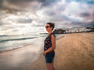 Fototapeta na wymiar Side view of a caucasian woman at Morro Jable Beach Fuerteventura