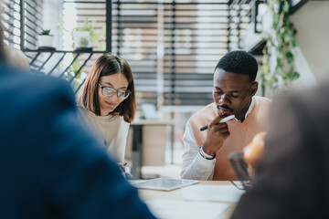 Diverse professionals collaborate in a modern office, analyzing financial statistics and...
