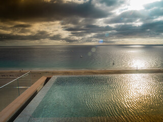 Aerial view of an infinity pool and the sea