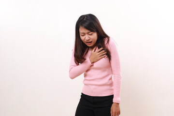 Pressure in the chest. Close-up photo of a stressed woman who is suffering from a chest pain and touching her chest
