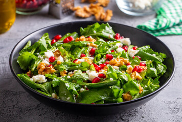 Arugula salad with cheese served with walnuts and pomegranate. Turkish name; Roka salatasi