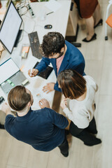 Business professionals collaborating in a creative office, working late into the night to meet a...
