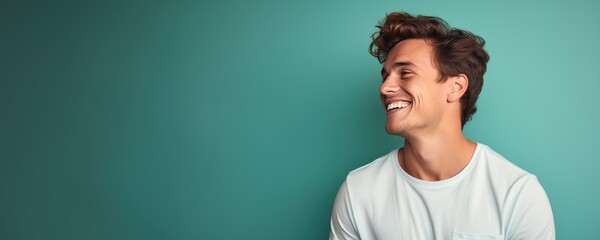 Portrait of a young Caucasian man against a solid green background