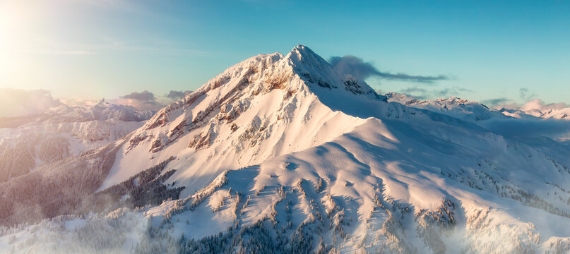Mnt Garibaldi Covered in Snow. Winter Season. Cloudy Sunset. Aerial View.